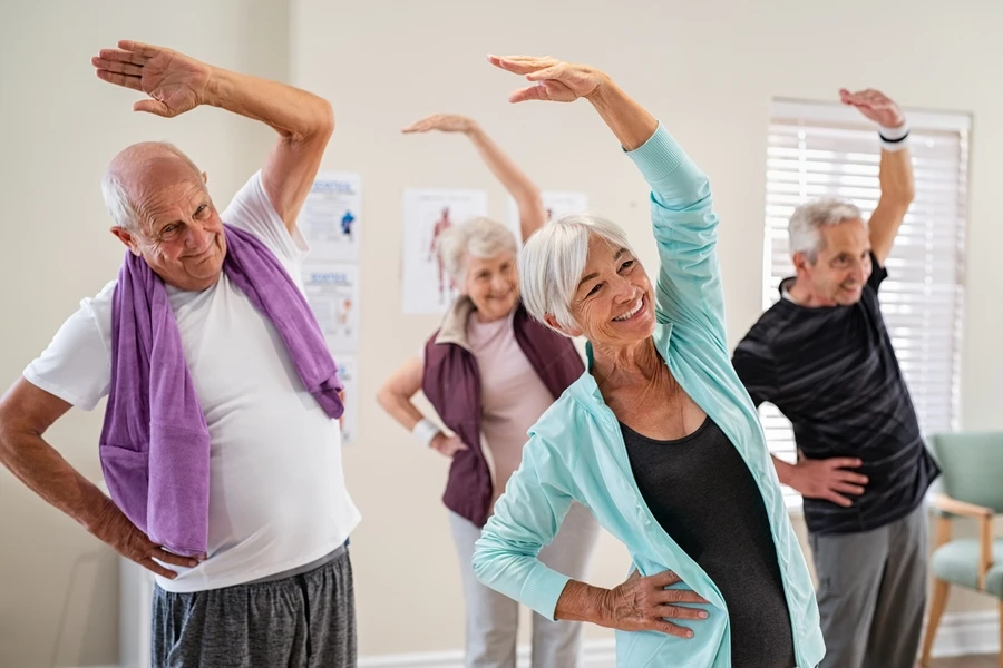 Older adults stretching their arms in an exercise class