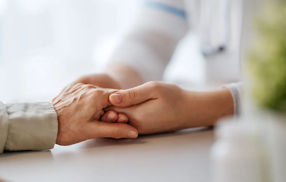 Close-up of two people holding hands