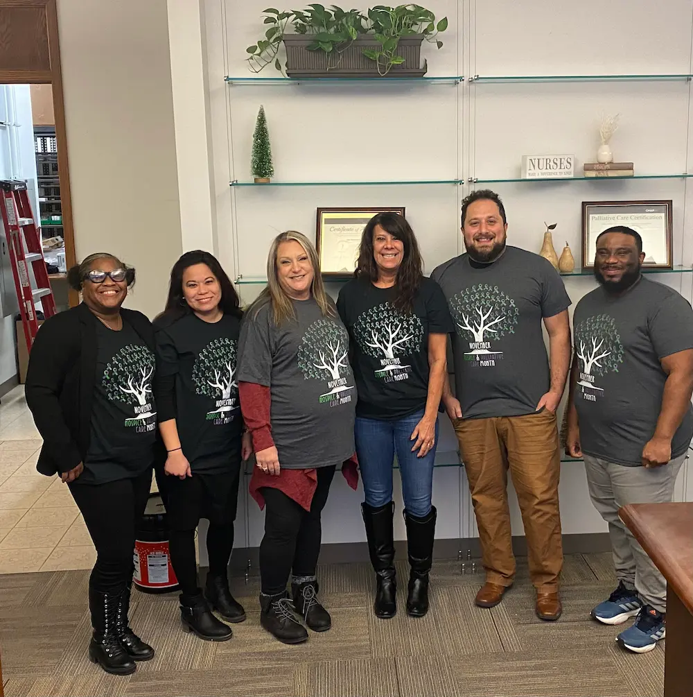 APEX volunteers in matching shirts posing in the office